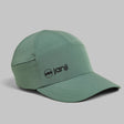 Janji Transit Tech Cap lightweight running hat in color spruce green